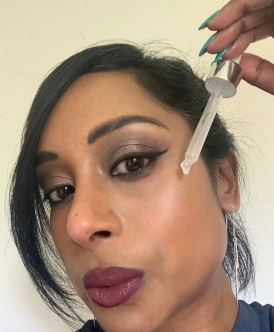 Lady using vitamin c serum for her face routine
