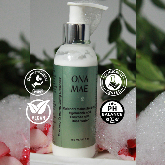 Green bottle of ONA MAE skincare product with certification logos on a blurred natural background